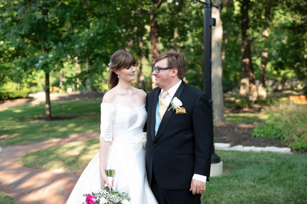 The bride and groom look into one another's eyes as a newly married couple. 